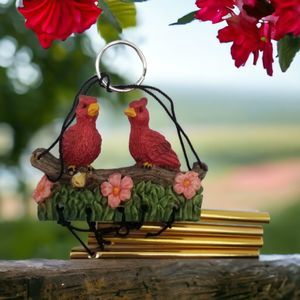 Two Red Birds Wind Chimes Resin 8"  Resting on Floral Branch Grass Metal Rod